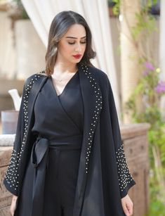 Set (handmade) consists of a black dress and an abaya decorated with crystals. Enhance your formal occasions and special events with the Lina set, a perfect combination of modesty and sophistication. This elegant set offers exceptional quality and refined style. FEATURES : Complementary Set: The Lina set consists of a black dress and a crystal-embellished abaya, creating a coordinated and elegant outfit. Dress : High Quality Material: Made of high quality black fabric, this dress is soft and com Elegant Outfit Dress, Embellished Abaya, Abaya Noir, Flowing Pants, Black Abaya, Abaya Dress, Elegant Sets, Outfit Dress, Womens Kimono