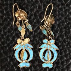 These dangle earrings are antiques that originate from the Qing Dynasty, where a noble woman would have worn an intricate design such as this for a special occasion.Antique stock, made by hand in the late 19th or early 20th century. Gilded silver with kingfisher feather (tian-tsui) finish. 2 inches tall with french hook ear wires. Antique Earrings With Historical Design For Ceremonial Occasions, Antique Drop Earrings With Historical Design, Antique Filigree Earrings For Ceremonial Occasions, Ornate Hallmarked Chandelier Dangle Earrings, Antique Historical Drop Earrings, Ornate Historical Design Earrings, Victorian Style Ceremonial Dangle Earrings, Victorian Style Ceremonial Earrings For Pierced Ears, Antique Jewelry With Historical Design Drop Earrings