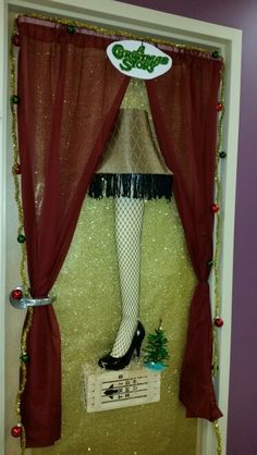 there is a christmas display in the door with stockings and stockings on it's legs