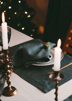 a place setting with candles and napkins