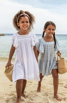 This playful cover-up will be your little one's favorite beach accessory thanks to swingy tassels tracing the layered flutter sleeves and ladder-stitched hem. Slips on over head UPF 50+ sun protection 100% viscose Hand wash, line dry Imported Girls Beach Dress, Gingham Picnic, Picnic Dress, White Tassel, Flowy Sleeves, Beach Kids, Blue Gingham, Cover Up Dress, Beach Dresses