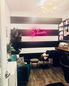 the salon is clean and ready for customers to use it's bright neon lights