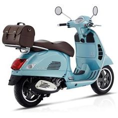 a blue scooter with luggage on the back