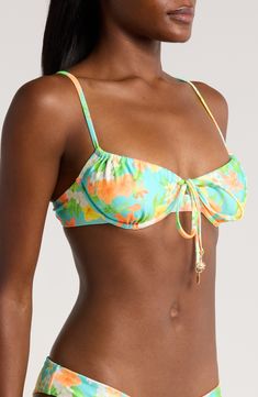 Dainty ties mark the center of this underwire bikini top with a colorful pattern that summons sunny-day energy. Clasps at back Lined Adjustable straps 88% polyester, 12% elastane Hand wash, dry flat Imported Underwire Floral Print Swimwear, Floral Print Underwire Swimwear, Green Knotted Straps Swimwear For Beach, Green Swimwear With Knotted Straps For Beach, Green Beach Swimwear With Knotted Straps, Beach Swimwear With Knotted Straps And Underwire, Underwire Swimwear With Knotted Straps For Beach, Beachwear Swimwear With Knotted Straps And Underwire, Underwire Beachwear Swimwear With Knotted Straps