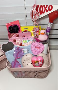 a pink basket filled with lots of different items