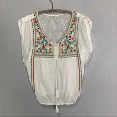 Willow & Clay Nwot Embroidered Peasant Blouse White Cotton Blouse With Brightly Embroidered Details Sleeves Have Casual Rolled Cuffs With Button Neckline Has Tassels Back Has Lace Inset Measurements Armpit To Armpit 19��” Length 23” Size Xs As2/425 White V-neck Top With Intricate Embroidery, Multicolor Bohemian Blouse With Lace Trim, Bohemian Multicolor Lace Trim Blouse, White Folk Peasant Top For Vacation, White V-neck Peasant Top With Floral Embroidery, Peasant Style Embroidered Top For Beach, White Folk Style Peasant Top For Vacation, Peasant Blouse With Floral Embroidery For Vacation, Spring Bohemian Top With Intricate Embroidery