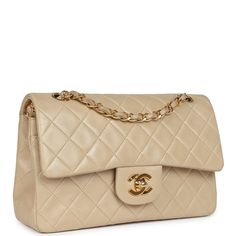 This Vintage Small Classic Double Flap bag is in Beige Lambskin with gold hardware, front flap with CC turnlock closure, tonal stitching, an interwoven gold tone chain link adjustable shoulder/crossbody strap, and signature half moon pocket on exterior.The interior is lined in beige leather with the "love letter" zipper compartment underneath the first flap, an "outer" slit pocket under the second flap, and an interior compartment with two open pockets separated by a "lipstick" compartment.Collection: 2-series (1991-1994)Origin: FranceCondition: New Excellent - . There are es to the CC turnlock. The exterior leather shows some to the flap corners, bottom corners, and light press at the back pocket. The exterior leather is a little discolored and shows The interior is clean with no or press Handbag Wallet, Wallet Accessories, Vintage Chanel, Classic Flap, Flap Bag, Handbag Accessories, Tote Handbags, Chanel Classic, Designer Handbags