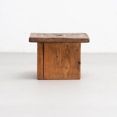 a wooden bench sitting on top of a white floor