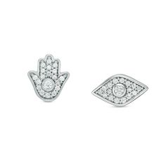 two small white gold and diamond earrings, one with an evil eye and the other with a hamsa hand