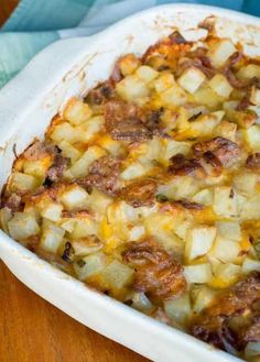 a casserole dish filled with potatoes and meat