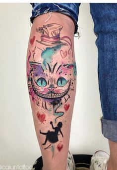 a woman's leg with tattoos on it and an image of a cat wearing a top hat