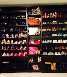 there are many pairs of shoes on the shelves in this closet that is full of them