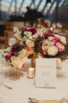 a table with flowers and place cards on it