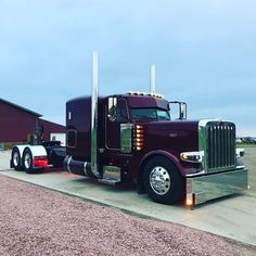 a large semi truck parked in front of a building