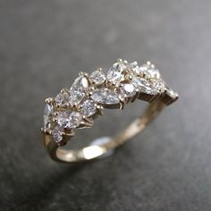 a gold ring with five pear shaped diamonds