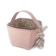 Storage made pretty....our little basket is perfect for gifting as well as storing nursery essentials, small toys, or attach our matching French Bunny Ornament for a unique Easter Basket! With pretty blush pink polka dot, and our signature French Floral, liner, this caddy coordinates with our nursery collection. Perfect for monogramming. storage made pretty! 100% Polyester Measures 6 in x 7in / 15 1/4 cm x 17 3/4 cm spot clean only and air dry Unique Easter Baskets, Pink Basket, Unique Easter, Storage Caddy, Fabric Basket, Small Toys, French Floral, Nursery Essentials, Unique Baby Gifts