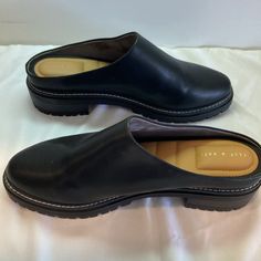 Size 11 Black Lug Sole Mules/Clogs Never Worn. Extreme Cushion Inside. Black Clogs With Leather Footbed For Work, Casual Round Toe Clogs For Work, Casual Workwear Clogs With Textured Sole, Casual Workwear Clogs With Round Toe, Casual Black Mules With Textured Sole, Black Clogs With Textured Sole For Spring, Workwear Clogs With Textured Sole And Round Toe, Black Almond Toe Clogs With Leather Sole, Black Slip-on Mules With Textured Sole