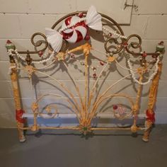 a metal bed frame with decorative decorations on it