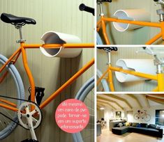 the orange bike is hanging on the wall and has two cups attached to it's handlebars