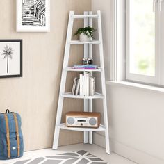 a book shelf in the corner of a room next to a window with pictures on it