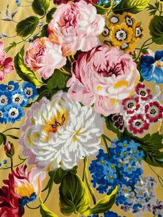 a bunch of flowers that are on a yellow background with blue, pink and white flowers