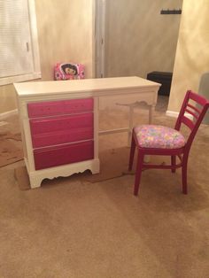 a chair and desk in a room with carpeted flooring, walls and windows