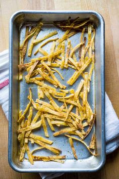 baked french fries in a baking pan on a wooden table