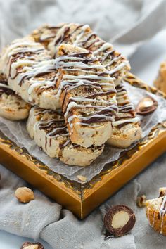 some cookies are sitting on a plate and drizzled with white icing