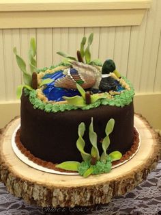 there is a chocolate cake decorated with birds and plants on the top of each layer