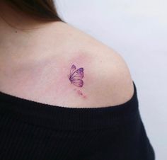 a woman's shoulder with a butterfly tattoo on the left side of her upper arm