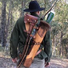 a man wearing a hat and holding an arrow in his back pocket with the bow attached to it