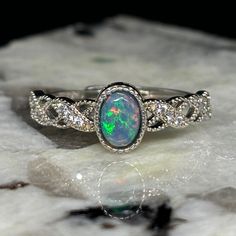 A Majestically Crafted Ring With A Bright Black Welo Opal. Type - Black Crystal Location - Welo, Ethiopia Size - 6mm X 4mm X 2mm Weight - 0.25 Cts Cut - Oval Pattern - Patchwork Rolling Flash Brightness - B4 Metal - .925 Sterling Silver Ring Size - Adjustable Full Video - Https://Www.Theopalsource.Com/Product-Page/Beautiful-Color-Patchwork-Black-Ethiopian-Custom-Made-Opal-Ring Shiny Rings, Opal Ring, Welo Opal, Black Crystals, Opal Rings, Women Accessories Jewelry, Product Page, Womens Jewelry Rings, Sterling Silber