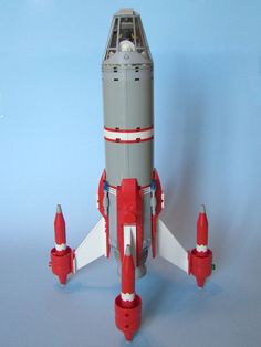 a lego model of a space shuttle with rockets on it's sides and the bottom