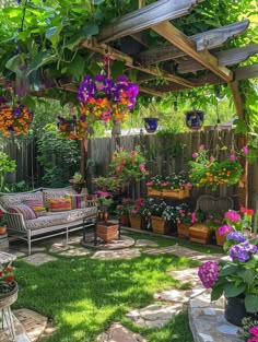 a garden with lots of potted plants and flowers hanging from it's roof