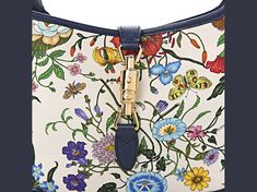 Gucci Canvas Flora Jackie O Hobo with blue agata leather trim features the iconic flora/fauna canvas known from the designer house. This stylish hobo features bright floral canvas with coordinating blue agata leather accents. Features a looping leather shoulder strap with a light brass buckle and a cross over strap with a light brass piston. This opens to a natural linen interior with space for daytime essentials.    Model: 550152  White floral canvas with Agata blue leather trim   Interior lini Gucci Canvas Bag With Adjustable Strap, Gucci Multicolor Tote Bag, Gucci Canvas Bags With Gold-tone Hardware, Designer Bags With Floral Print For Spring, Designer Floral Print Bags For Spring, Gucci Multicolor Shoulder Bag For Daily Use, Gucci Canvas Top Handle Shoulder Bag, Everyday Multicolor Gucci Shoulder Bag, Designer Leather Bag With Floral Print