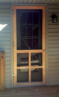 an open door on the side of a house with a bird in it's cage