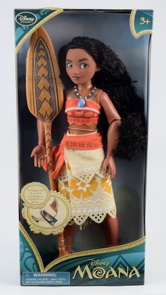 the doll is wearing an orange top and white skirt with her hair pulled back, holding a paddle