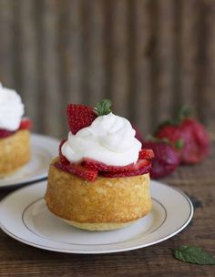 strawberry shortcakes with whipped cream and fresh strawberries on the side, ready to be eaten