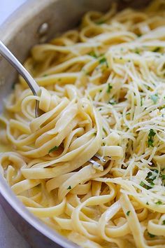 a pan filled with pasta and parmesan cheese on top of it's side