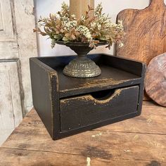 an old wooden box with flowers in it