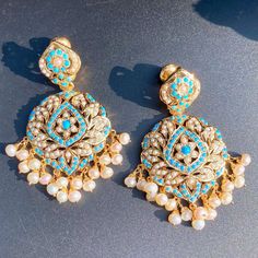 Featuring a pair of finely crafted pearl and turquoise earrings in gold plated silver. The earrings weigh a comfortable to wear 25 gms and come with a bombay screw closure. All our Gold Plated Jewellery is made using 925 Silver as the base metal. The beads in hanging and strings (like in our 22k gold jewelry) are always precious freshwater pearls and high quality ruby, emerald and sapphire beads. The default choice for studded stones is precious freshwater pearls and the red, green and navy blue 22k Gold Jewelry Necklaces, 22k Gold Jewelry, Pearl Necklace Set, Gold Jewelry Necklace, Emerald Necklace, Gold Bangle Bracelet, 22k Gold, Turquoise Earrings, Gold Plated Silver