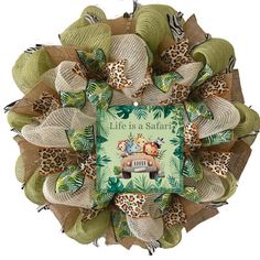 a wreath made out of burlocks and fabric with an animal print on it