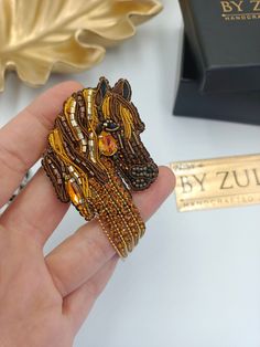 Introducing my exquisite brown horse brooch, a symbol of grace, strength, and elegance! 🐴🌟 Crafted with meticulous attention to detail, this brooch captures the majestic beauty of a horse in a subtle yet captivating form. The rich brown tones evoke a sense of earthy warmth, reminiscent of the peaceful presence of a horse in a tranquil meadow. 🍂🏞️ The brooch highlights the horse's gentle features and flowing mane, reflecting its innate grace and vitality. This piece is a tribute to the magnif Elegant Brown Formal Brooches, Brown Brooch Jewelry Gift, Luxury Handmade Brooches For Gifts, Brown Jewelry Brooch For Gifts, Horse Brooch, Pumpkin Pin, Grace Symbol, Unique Brooch, Starfish Earrings