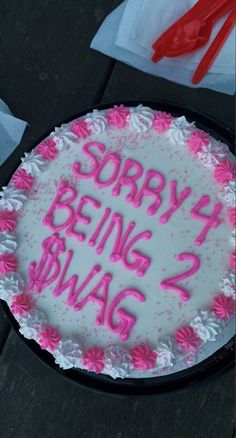 a birthday cake with pink frosting and writing on the top that says sorry being bmag