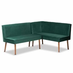 a green velvet corner sofa with wooden legs