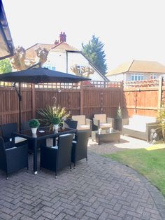 an outdoor dining area with patio furniture and umbrella