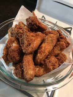 fried chicken sticks in a glass bowl on a table