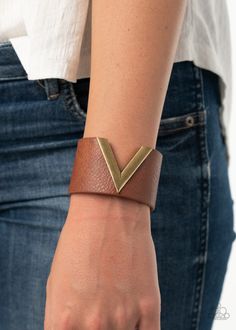 A v-shaped brass frame slices into the center of a thick brown leather band, creating a chic centerpiece around the wrist. Features an adjustable snap closure.

Sold as one individual bracelet. Leather Products Ideas, Leather Wrist Cuff, Paparazzi Accessories Jewelry, Diy Leather Bracelet, Leather Jewels, Leather Jewellery, Brown Bracelet, Simple Leather, Bracelet Cuir