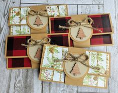 four cards with christmas trees on them and twine tied to each other, sitting on top of a wooden table