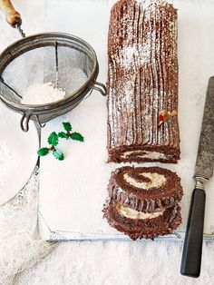 a piece of cake sitting on top of a cutting board next to a knife